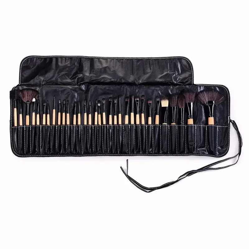 Set of makeup brushes in a black roll-up case with individual slots.