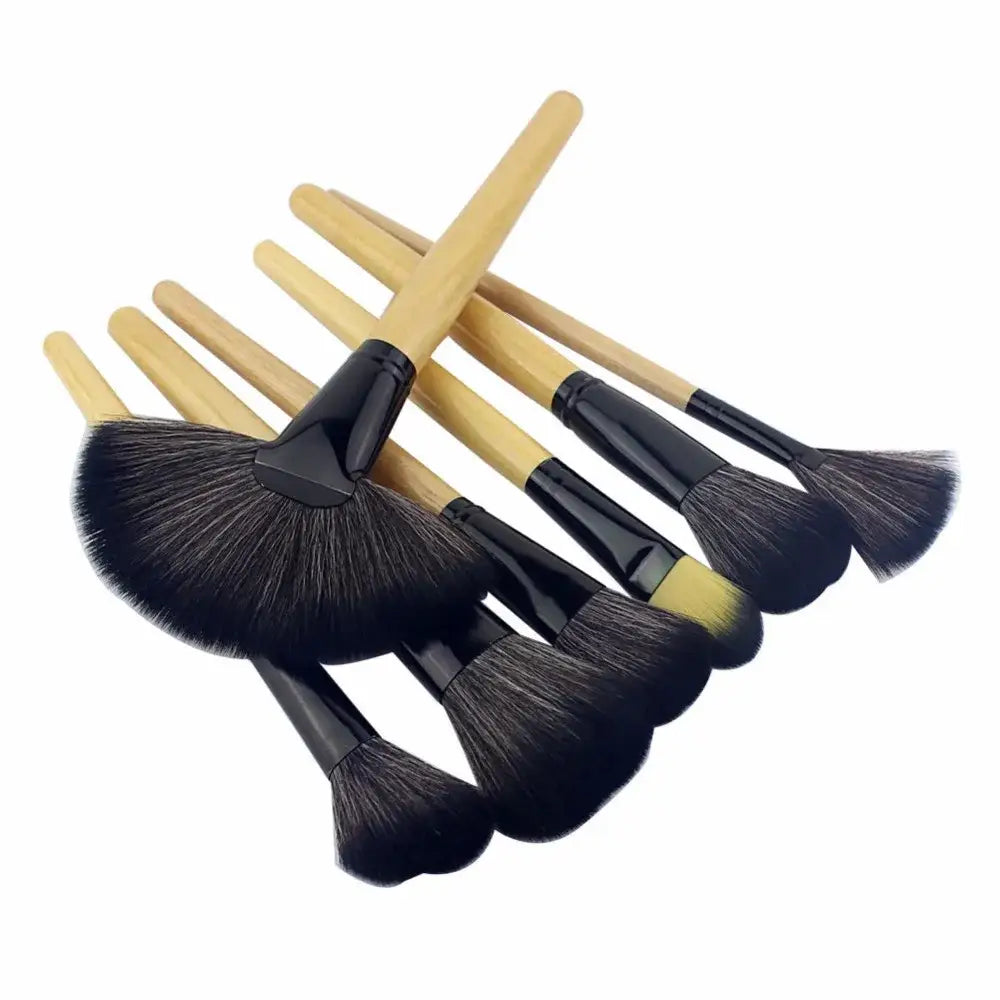 Set of makeup brushes with black bristles and wooden handles.