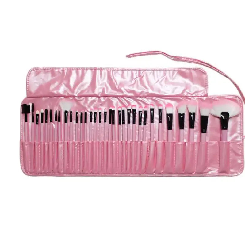 Pink makeup brush set rolled out in a shiny fabric case.