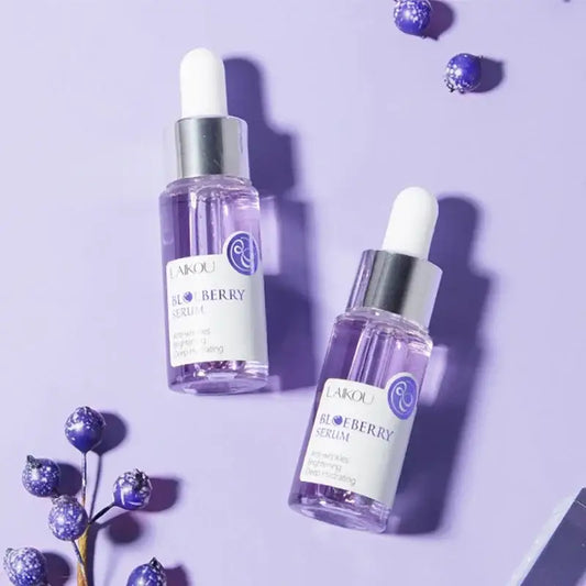 Purple glass dropper bottles containing skincare serum or oil.