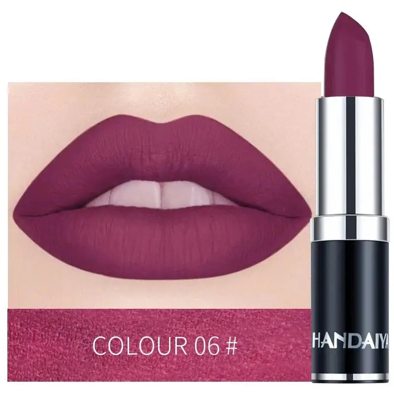 Deep purple matte lipstick with a matching lip swatch.