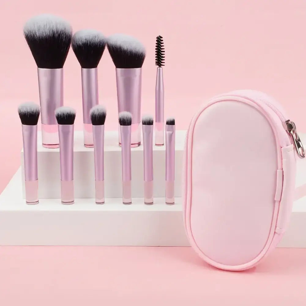 Set of makeup brushes with a pink carrying case.