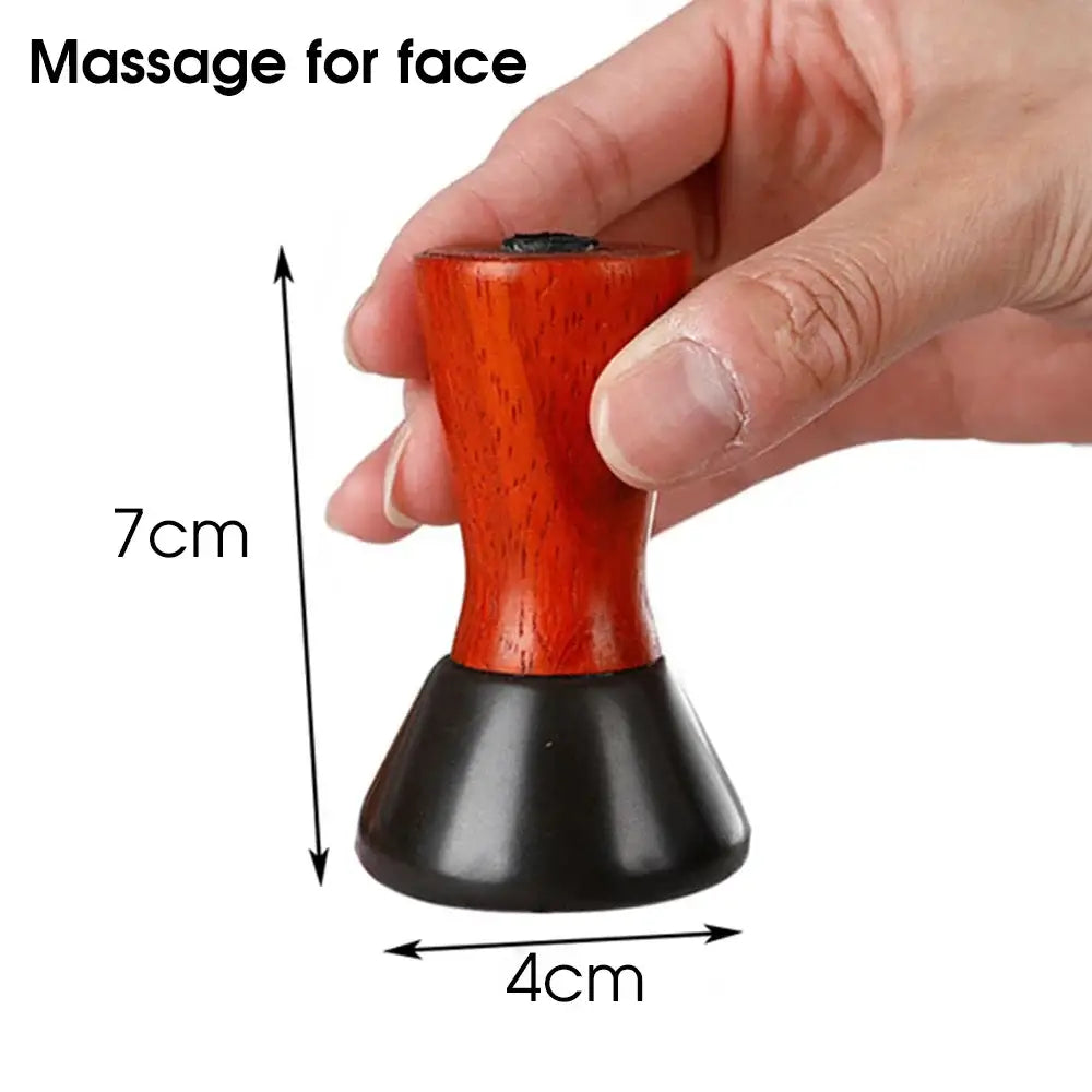 Red and black wooden facial massage tool with measurements indicated.