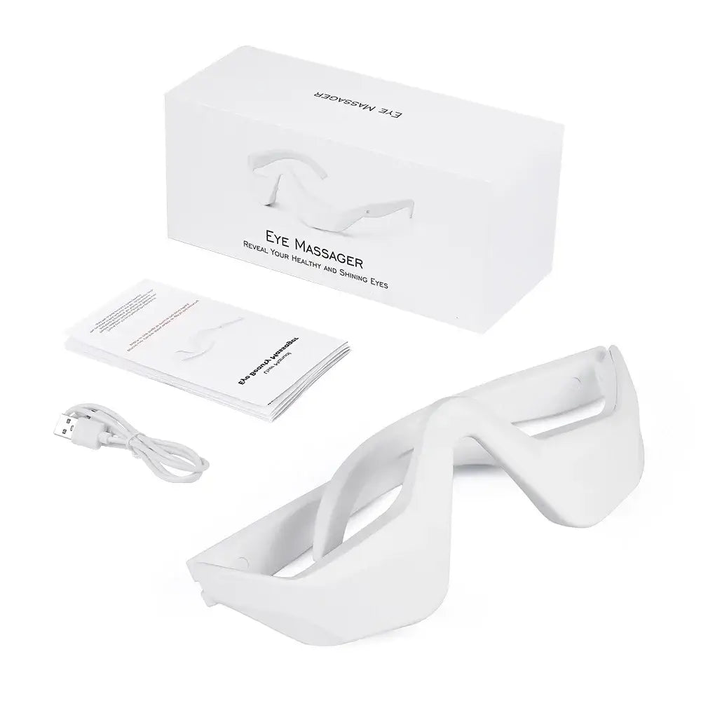 Eye massager device with a sleek white design and accompanying accessories.