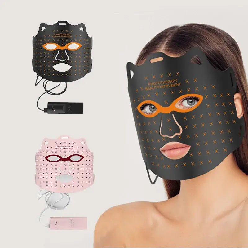 LED light therapy face mask with orange eye openings and a dark perforated surface.