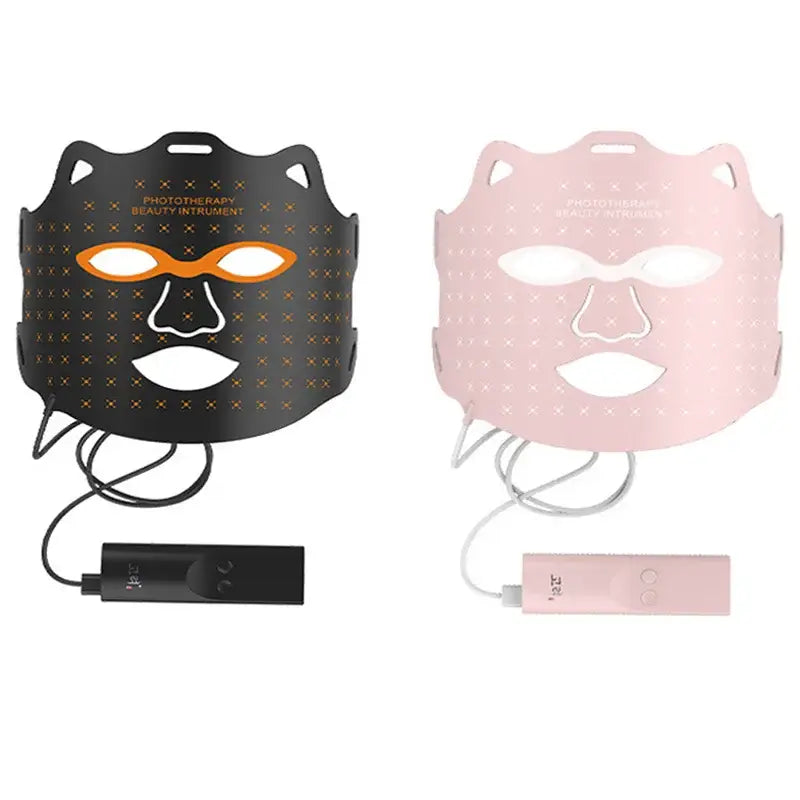 Two facial masks for skincare, one black and one pink, with attached battery packs.