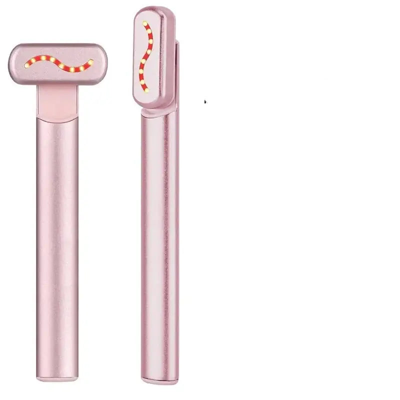 Pink facial massage roller with red light therapy functionality.