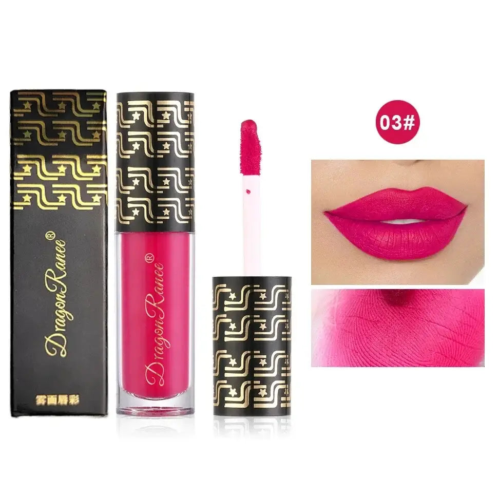 Bright pink liquid lipstick with ornate gold and black packaging.