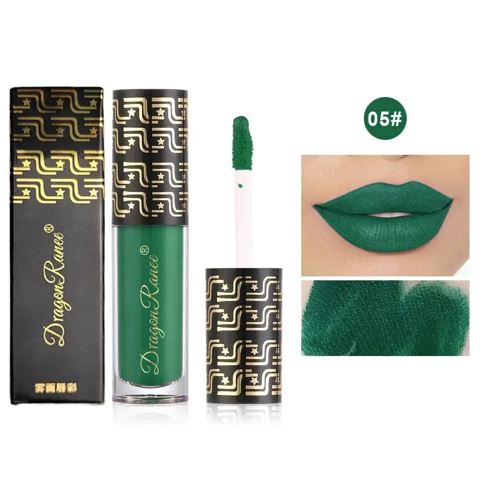 Green liquid lipstick with ornate gold-patterned packaging.