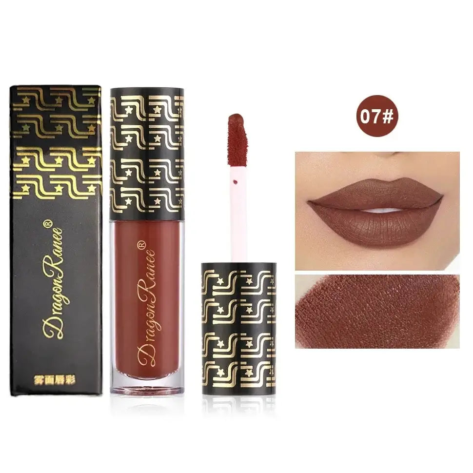 Liquid lipstick product with packaging featuring a geometric pattern and swatches showing the color.