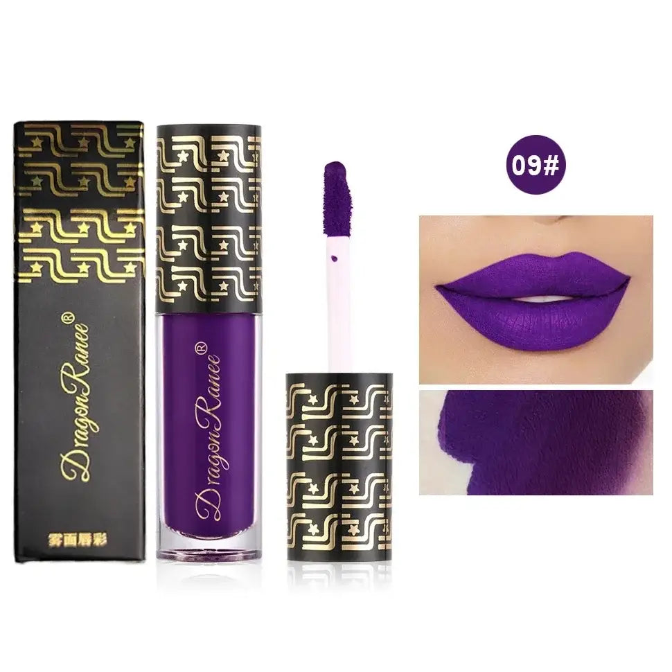 Purple liquid lipstick with ornate gold-patterned packaging.