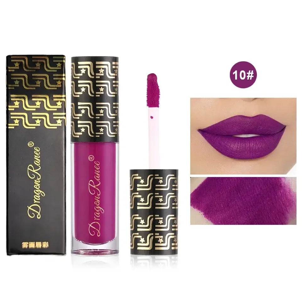 Vibrant purple liquid lipstick with ornate gold-patterned packaging.