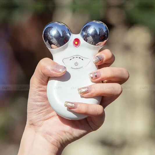 White plastic toy or gadget with large reflective eyes and a red button nose.