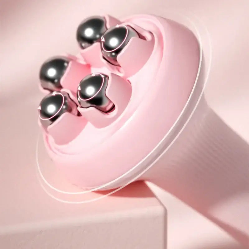 Pink handheld massager with metallic spherical nodes.