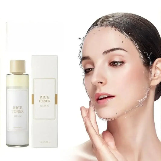 Bottle of rice toner skincare product alongside a woman’s face with water droplets.