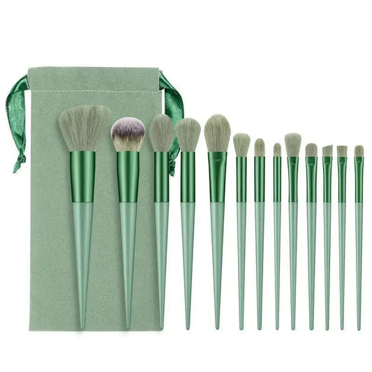 Set of mint green makeup brushes with a matching storage pouch.