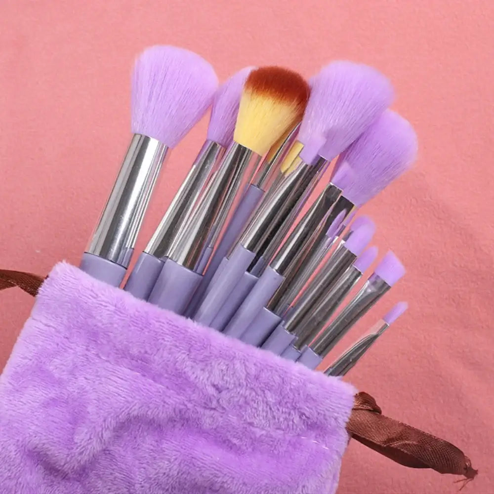 Set of purple makeup brushes in a fluffy purple holder.