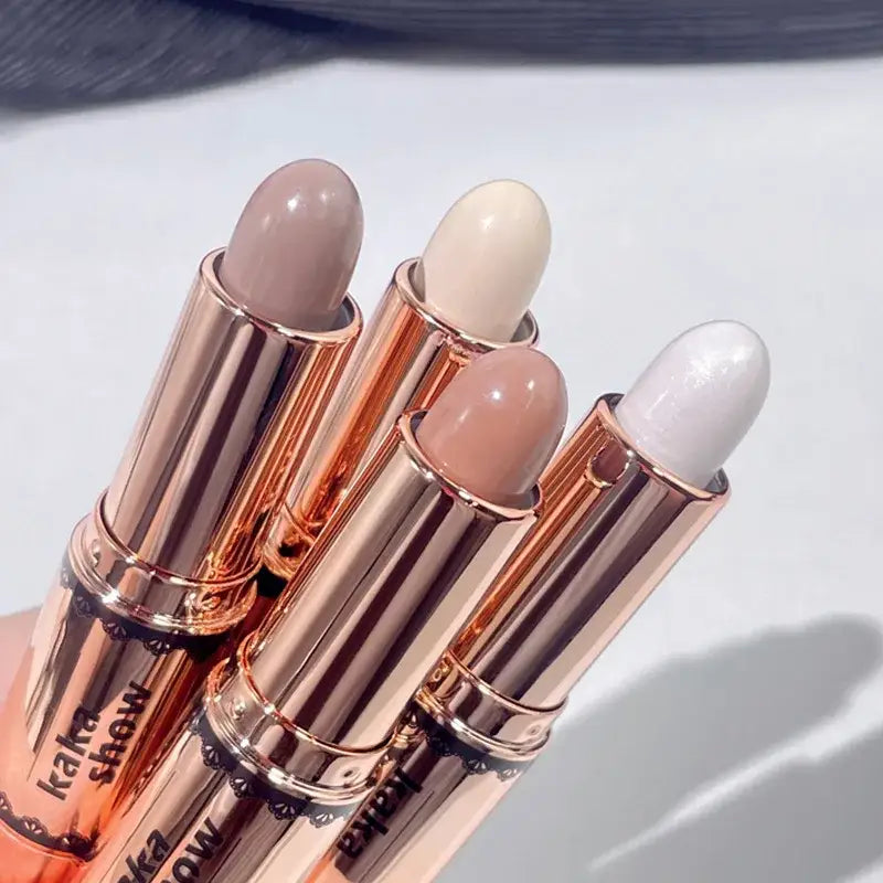 Four metallic lipstick tubes in rose gold and copper tones with nude-colored lipstick tips visible.