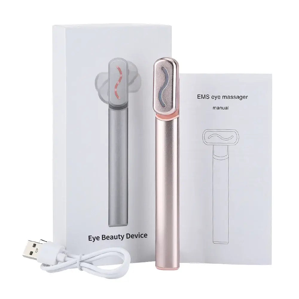 Eye massager device with a sleek, pen-like design in rose gold color.