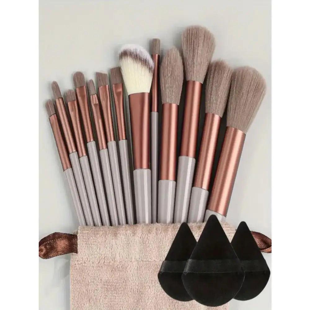 Set of makeup brushes with rose gold handles and soft bristles.