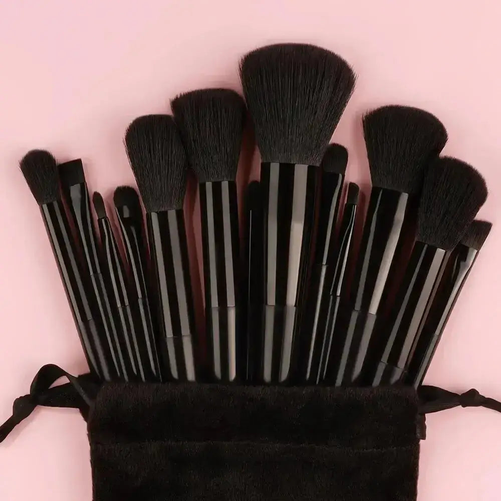 Set of makeup brushes in a black pouch.