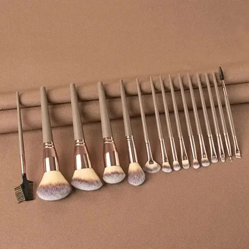 Set of makeup brushes hanging from a rod.