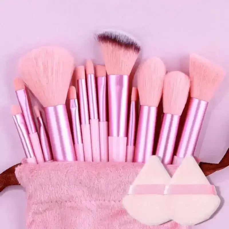 Set of pink makeup brushes with soft bristles in various shapes and sizes.