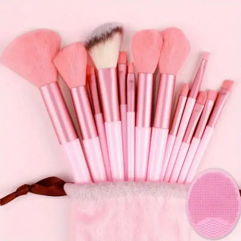 Set of pink makeup brushes with various shapes and sizes.