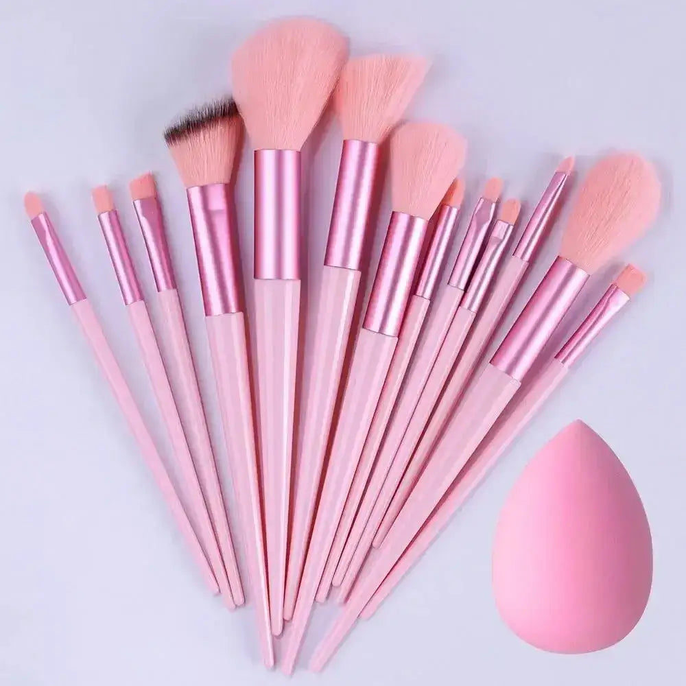 Set of pink makeup brushes and a beauty blender sponge.