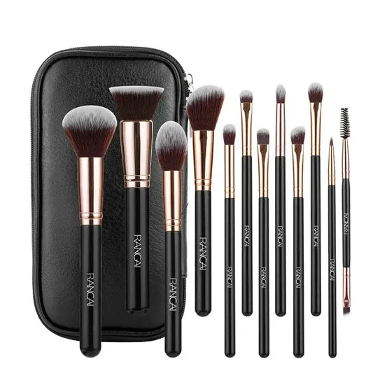 Set of makeup brushes with black handles and rose gold ferrules in a black carrying case.