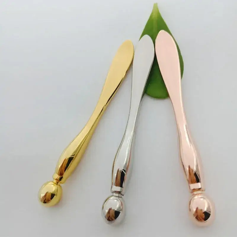 Three metallic spoons in gold, silver, and rose gold colors.