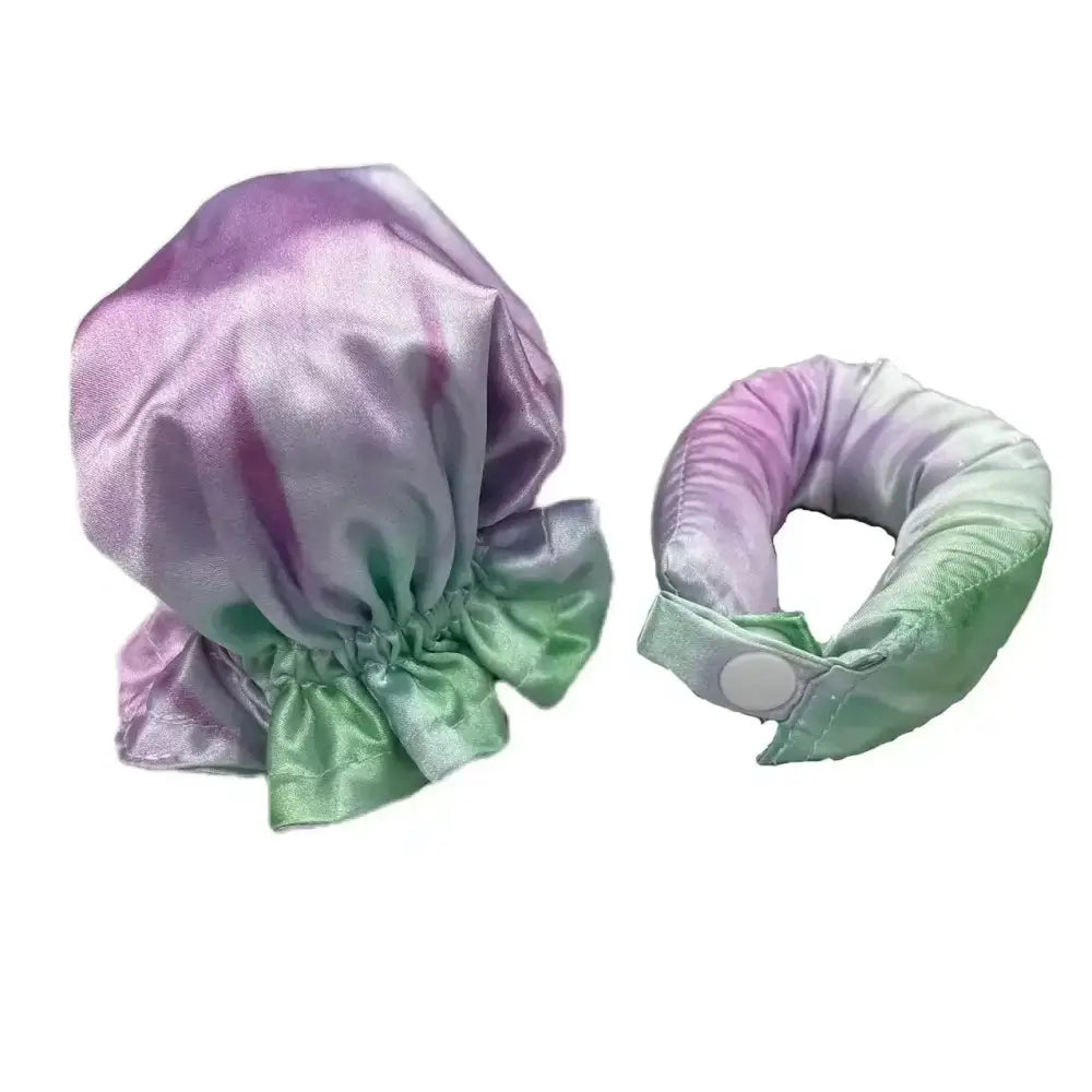 Satin or silk bonnet and matching neck pillow in ombre purple and green colors.