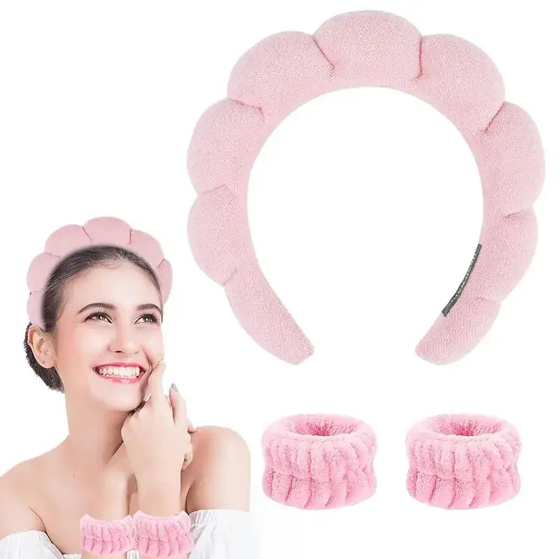 Pink plush headband with a scalloped edge design.