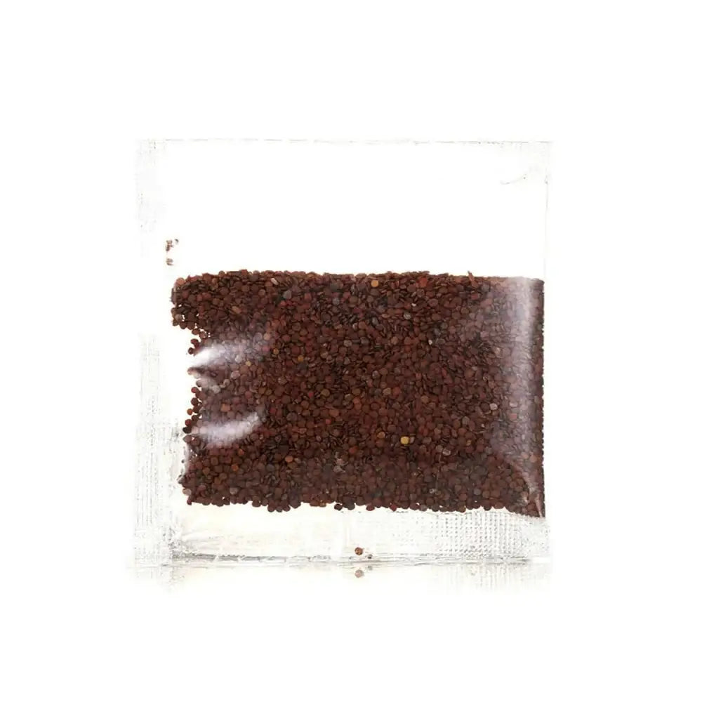 Clear plastic bag containing dark brown coffee grounds.