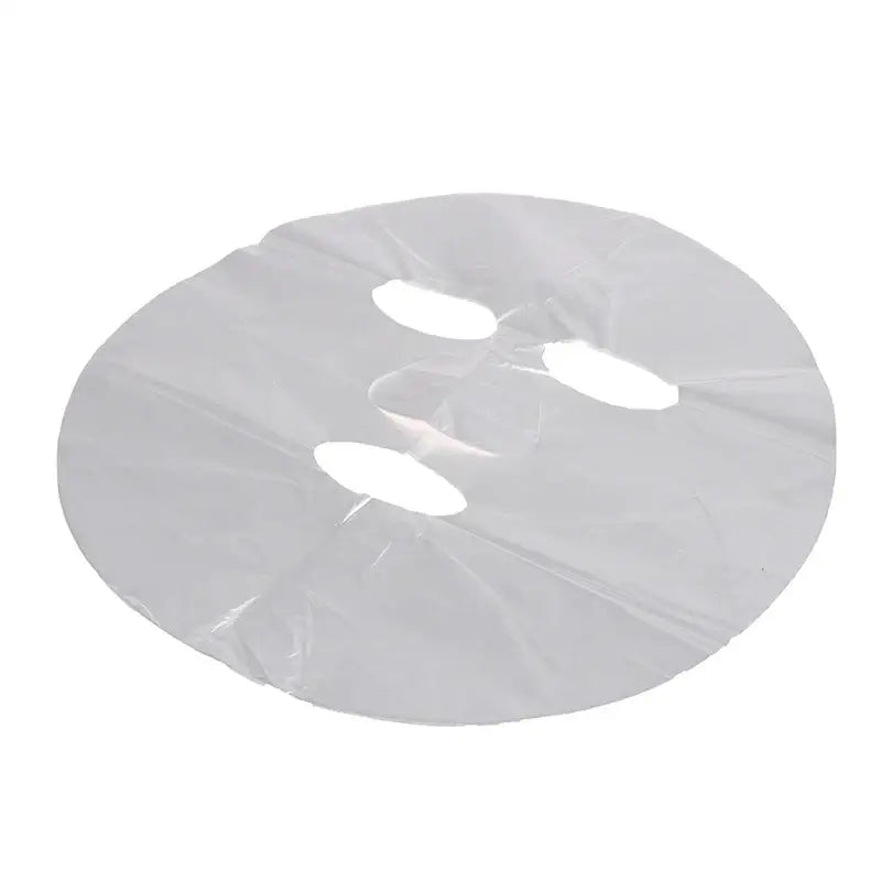 White sheet face mask with eye and mouth cutouts.