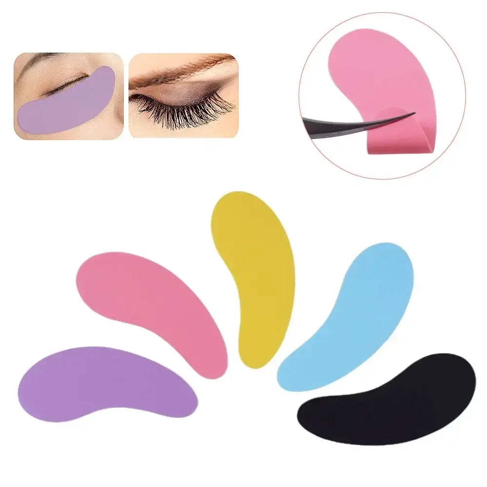 Colorful silicone eye shadow shields or applicators in various curved shapes.