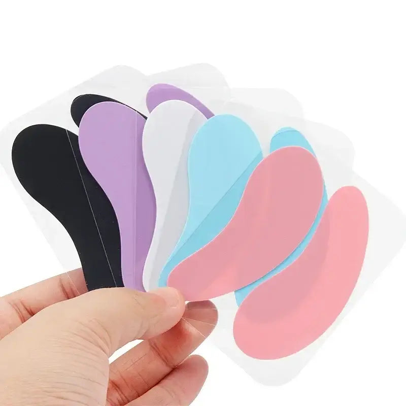 Colorful silicone gel eye patches or masks held in a hand.