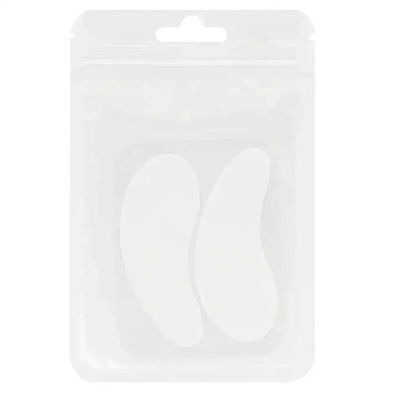 Packaged pair of white, crescent-shaped objects, likely eye patches or gel pads.