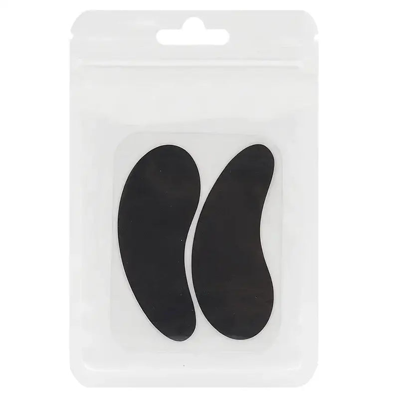 Two black, curved, comma-shaped objects on a white packaging card.