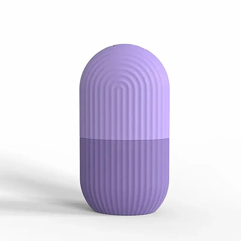 Lavender-colored capsule-shaped object with vertical ridges on its surface.