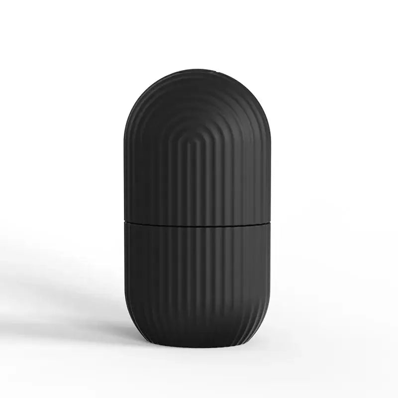 Matte black capsule-shaped container with vertical ridges.