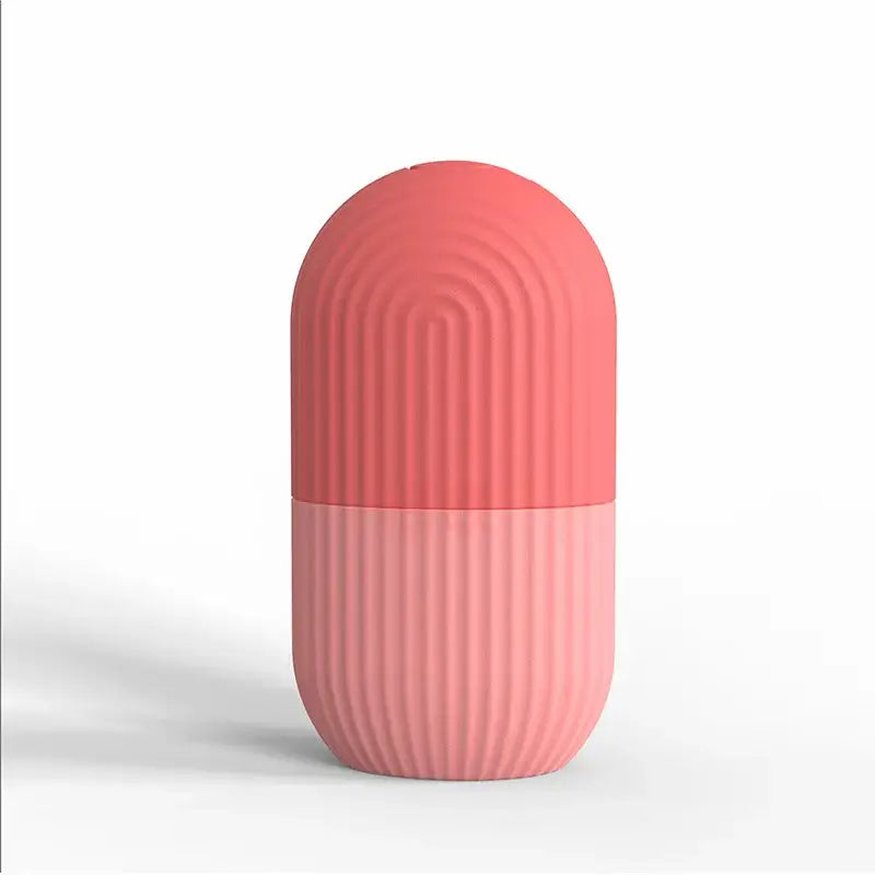 Pink capsule-shaped object with ribbed texture and two-tone coloration.