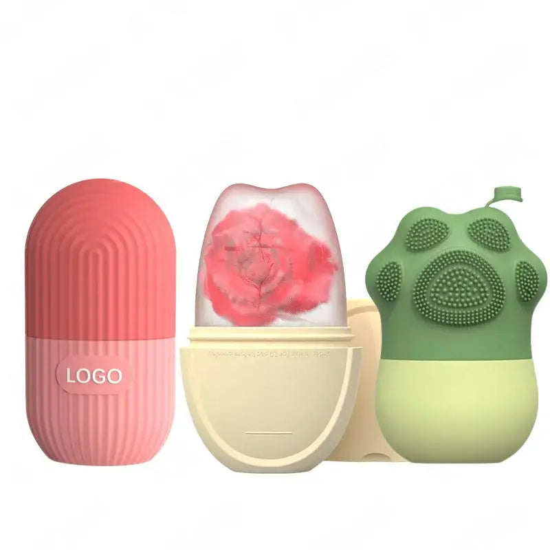 Three uniquely shaped silicone facial cleansing brushes in pink, clear with red, and green colors.