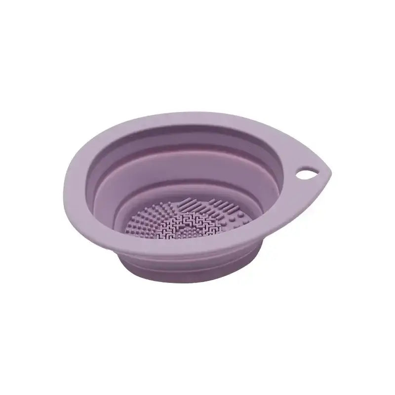 Collapsible silicone strainer or colander in a light purple color.