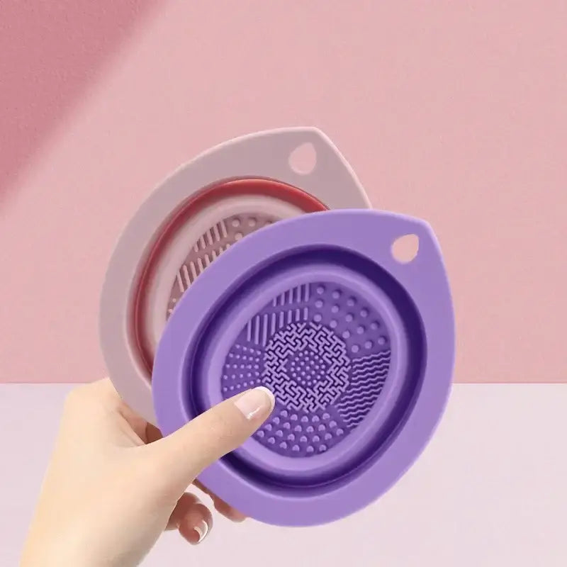 Collapsible silicone strainer with a textured bottom and handle.