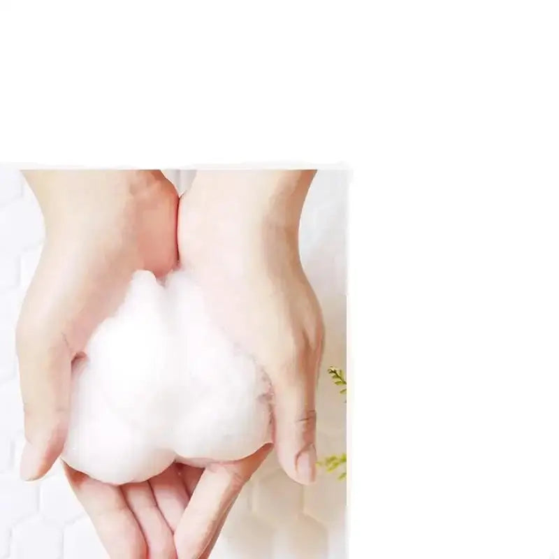 Fluffy white cotton ball or puff held in cupped hands.