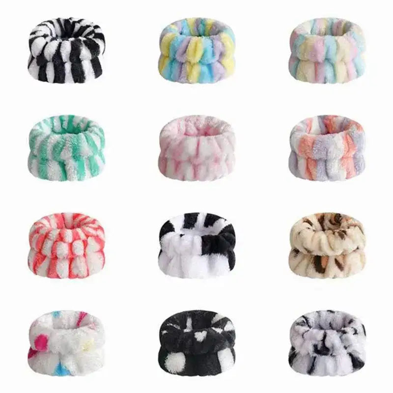 Colorful, fluffy scrunchies or hair ties arranged in a grid pattern.