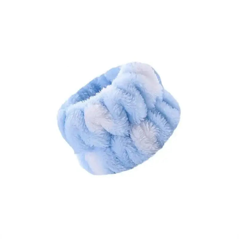 Fluffy light blue scrunchie or hair tie made of soft fabric.