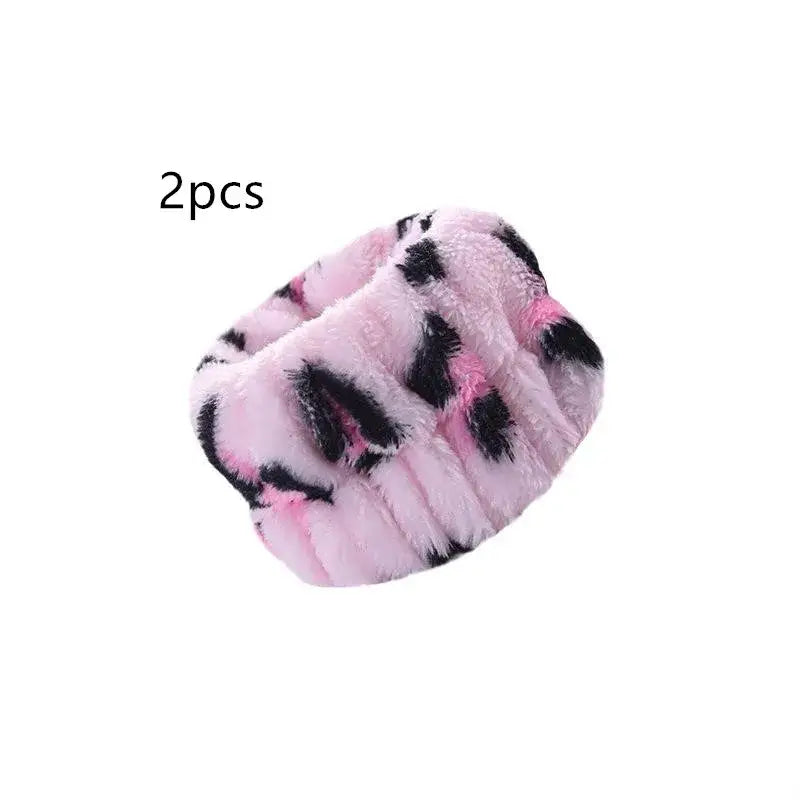 Fluffy pink and black patterned slipper or house shoe.