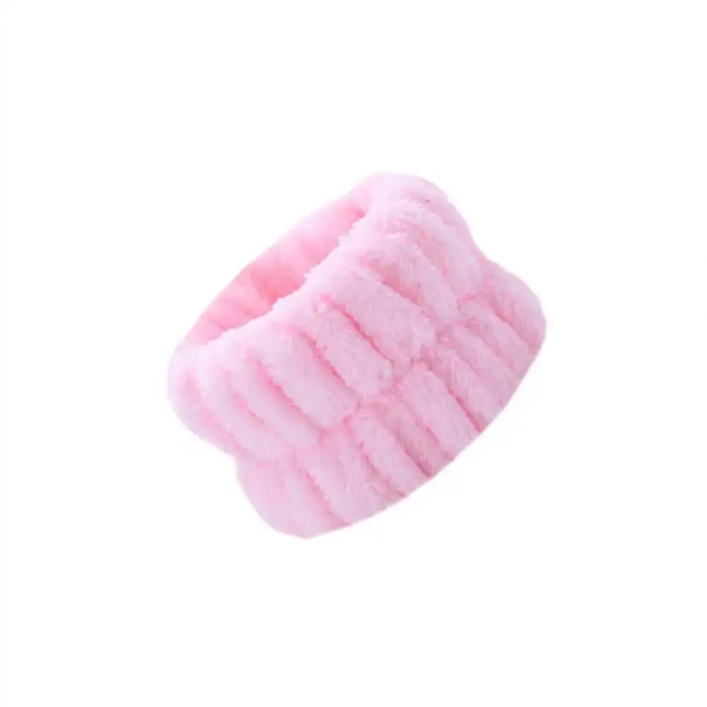 Pink fluffy headband or hair accessory.